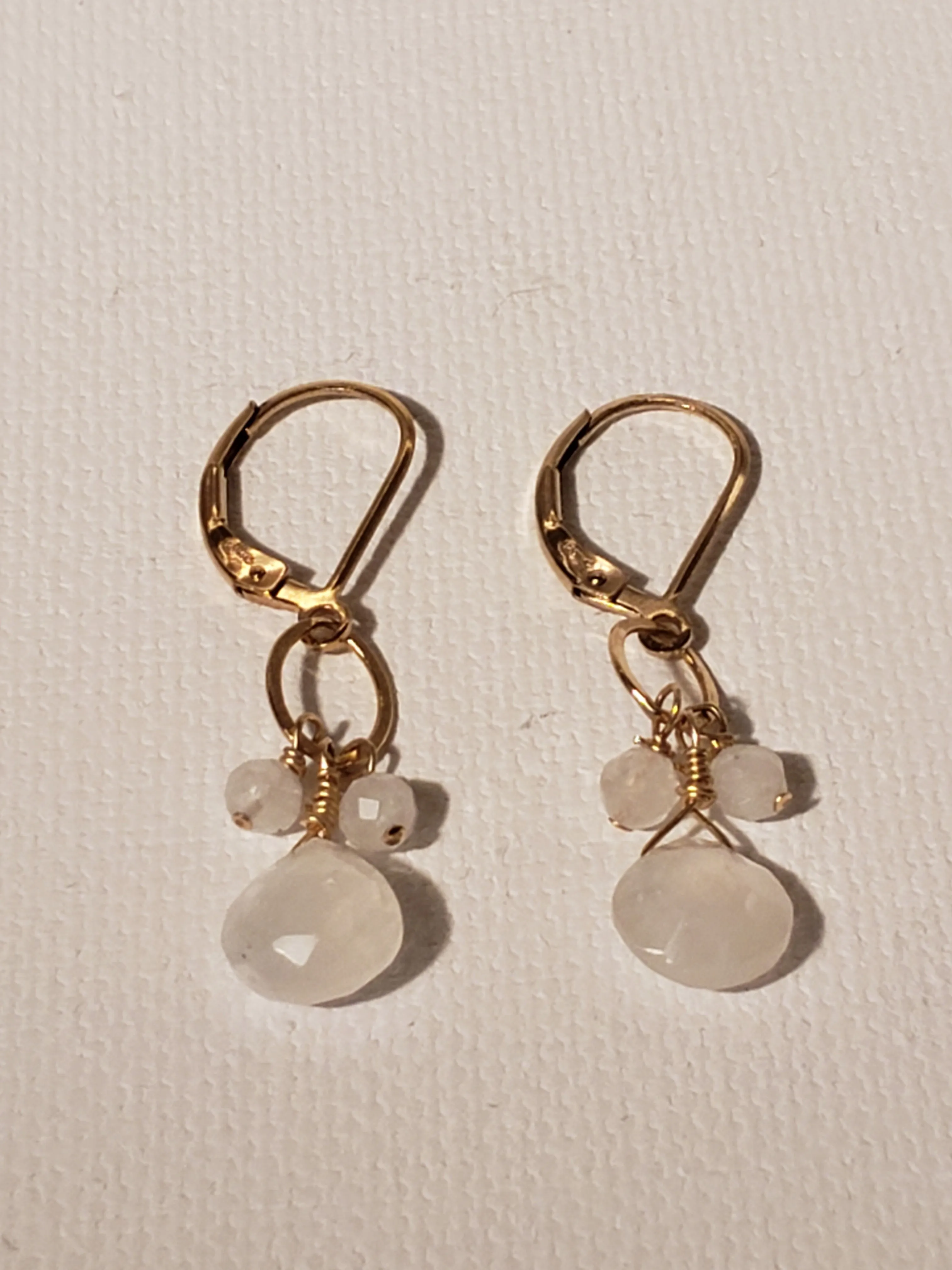 An Iridescent Faceted Moonstone Tear Drop With Cluster of Stones on Gold-Filled Lever Back Earring.